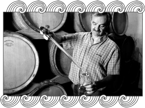 Hugues Godmé, Champagne winemaker, tasting from barrel in his cellar, framed with Dynamic Cellars wave design
