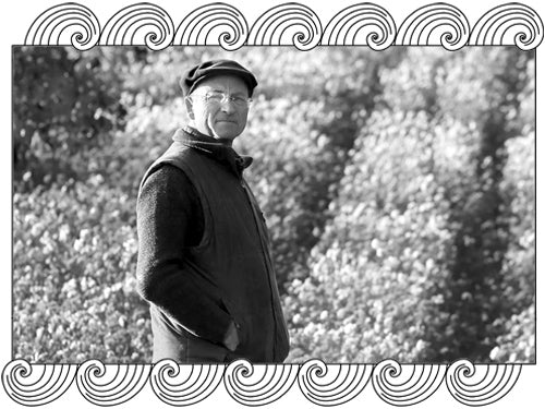 Château des Tours winemaker in his Southern Rhône vineyard, framed with Dynamic Cellars wave design