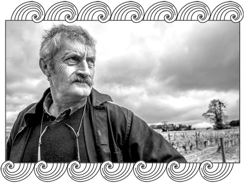 Clos Rougeard winemaker in his Saumur-Champigny vineyard, framed with Dynamic Cellars wave design