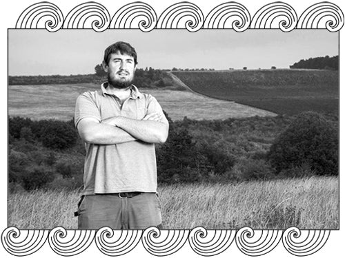 Marc Soyard, Domaine de la Cras winemaker, overlooking his Dijon hillside vineyard, framed with Dynamic Cellars wave design