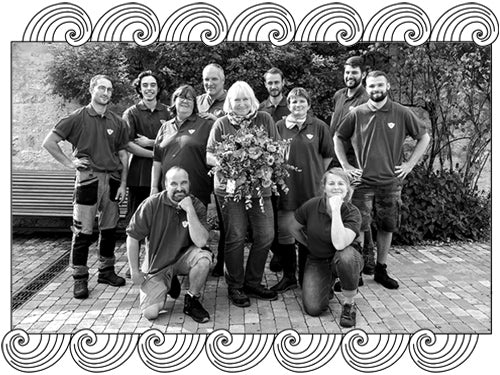 Domaine de la Vougeraie, Burgundy winemaking team gathered outdoors, framed with Dynamic Cellars wave design