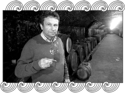Domaine du Clos Naudin, Vouvray winemaker tasting in his barrel cellar, framed with Dynamic Cellars wave design