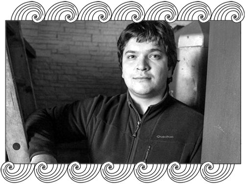 Domaine Georges Noëllat, Côte de Nuits winemaker, photographed in his cellar, framed with Dynamic Cellars wave design