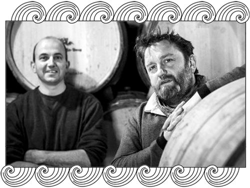 Domaine Guillot-Broux, Burgundy winemakers among barrels in their cellar, framed with Dynamic Cellars wave design