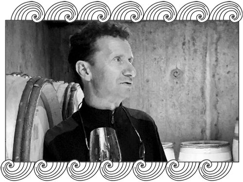 Domaine Lignier, Côte de Nuits winemaker tasting in his barrel cellar, framed with Dynamic Cellars wave design
