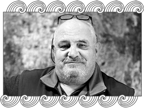 Jules Desjourneys, Beaujolais winemaker, portrait in the cellar, framed with Dynamic Cellars wave design