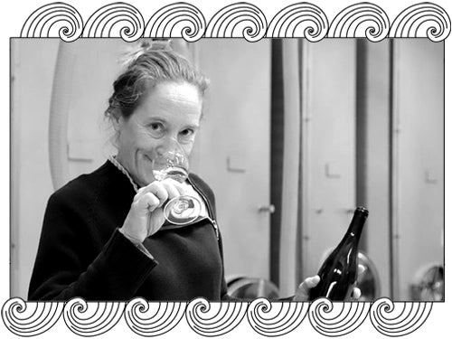 Domaine Moreau-Naudet, Chablis winemaker, tasting wine in her cellar, framed with Dynamic Cellars wave design