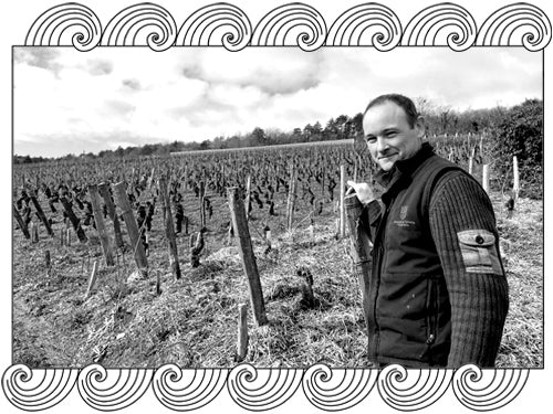Stéphane Magnien, Côte de Nuits winemaker, among his dormant winter vines, framed with Dynamic Cellars wave design