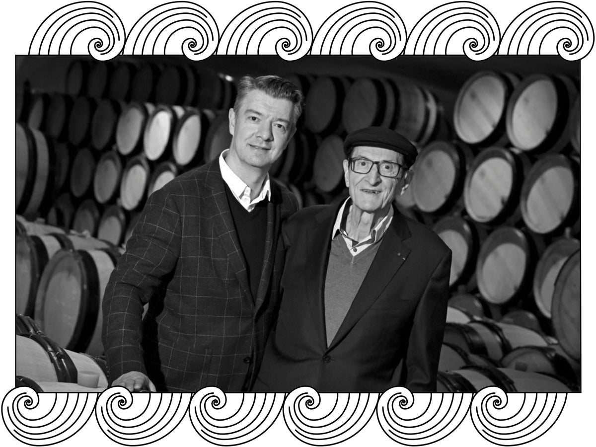 E. Guigal: two generations of the family in the barrel cellar, Rhône, framed with Dynamic Cellars wave design
