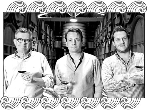 Famille Perrin, Rhône winemakers, three generations in their barrel cellar, framed with Dynamic Cellars wave design
