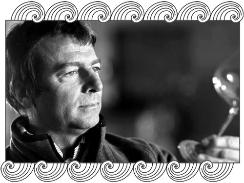 Giacomo Conterno, Barolo winemaker, examining wine in the glass, framed with Dynamic Cellars wave design