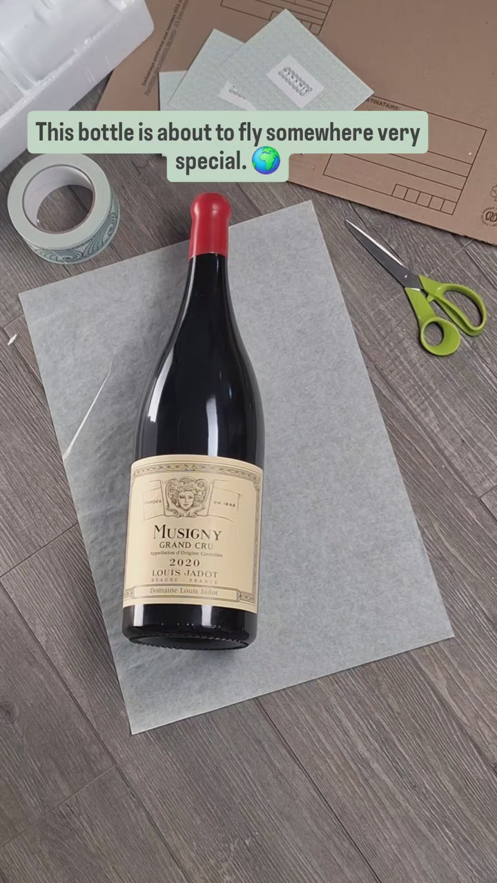 Hand-packing a bottle of Musigny Grand Cru, Maison Louis Jadot, for shipping to Prague