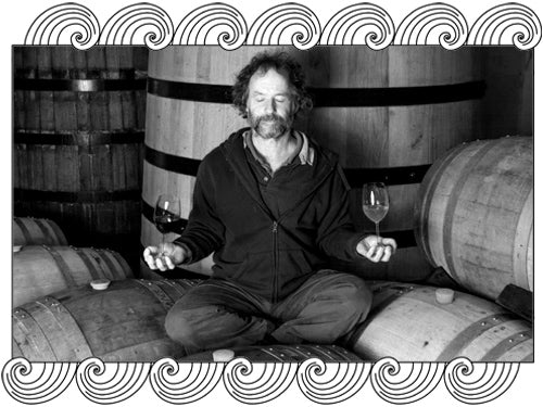 Renaissance Vineyards winemaker meditating on barrels in the cellar, framed with Dynamic Cellars wave design
