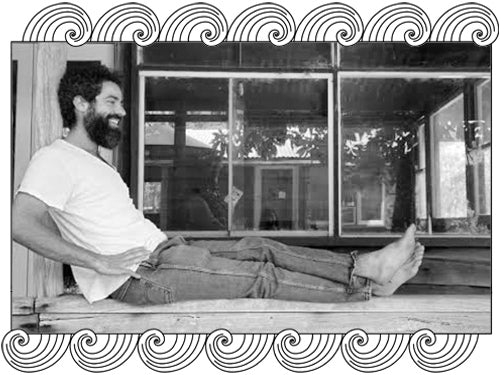 Sam Vinciullo, Australian natural winemaker, relaxing outside his winery, framed with Dynamic Cellars wave design